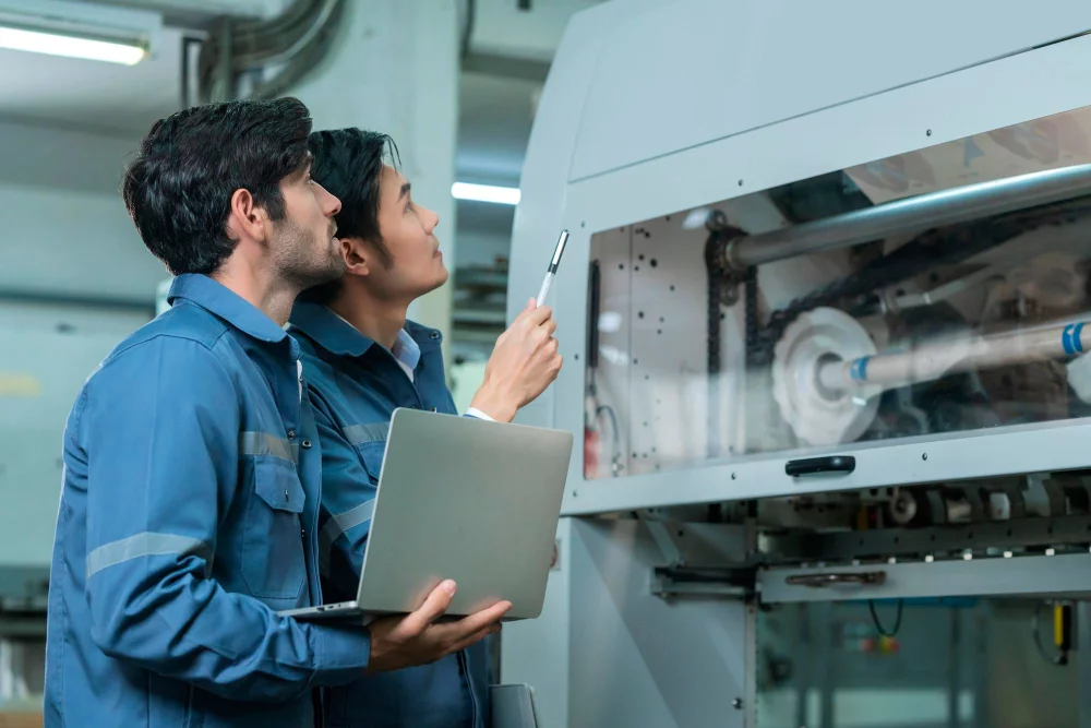 male-asian-caucasian-engineer-professional-having-discussion-standing-consult-machine-factory-two-expert-coworker-brainstorm-explaining-solves-process-cnc-operate-machine